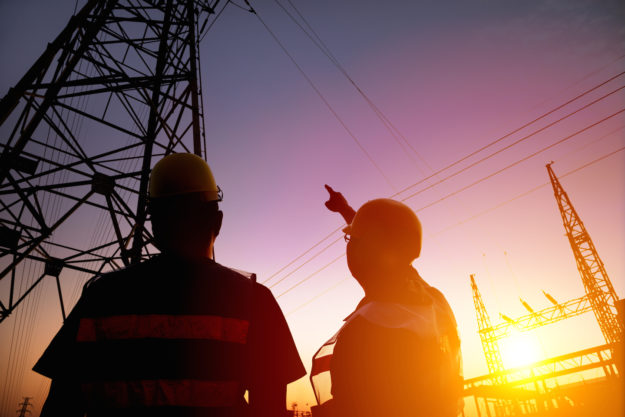 Two Worker Watching The Power Tower And Substation With Sunset Background Two Worker Watching The Power Tower